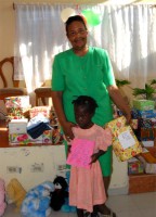 Founder of the Yolanda Thervil Foundation distributing the Make Jesus Smile United Caribbean Trust shoeboxes in Haiti